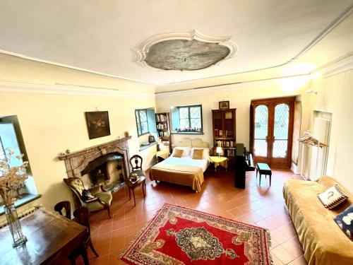 a living room with a couch a bed and a fireplace at Villa De Rubeis Florit in Tarcento