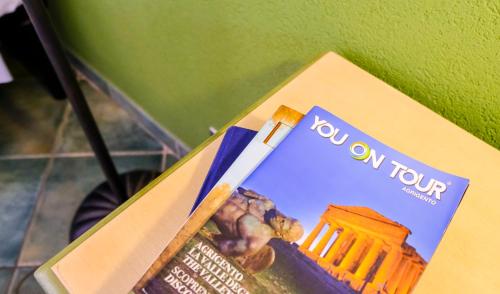a toothbrush sitting on top of a book at Hotel Baglio Di Scopello in Scopello