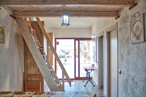 a room with a wooden staircase in a house at B&b Trebenoro in Lotzorai