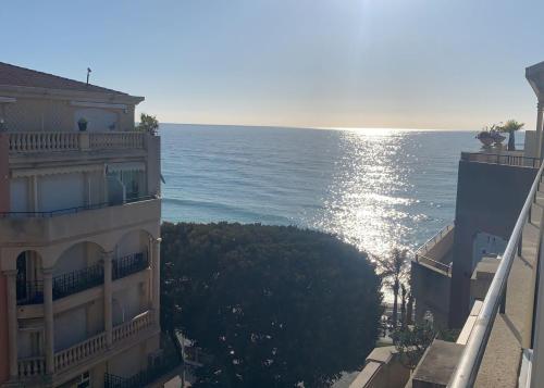 a view of the ocean from a balcony of a building at Attico Victoria Palace suggestivo e spettacolare in Menton
