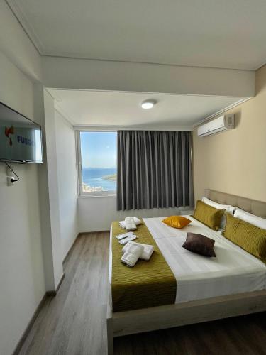 Una cama o camas en una habitación de Relax Mea Hotel