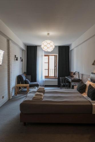 a bedroom with a large bed and a living room at Trybunalska in Lublin