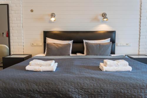 a bedroom with a large bed with towels on it at Trybunalska in Lublin