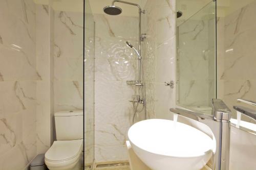 a bathroom with a shower and a toilet and a sink at Dimitris Residence 1 in Kalami