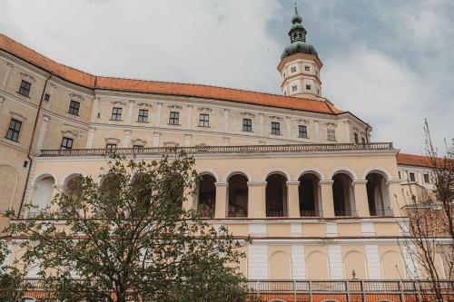 a large building with a clock tower on top of it at Vinný sklep Rozárka in Drnholec