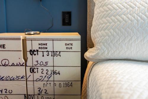 a stack of boxes sitting next to a bed at The Schoolhouse Hotel, Trademark Collection by Wyndham in White Sulphur Springs