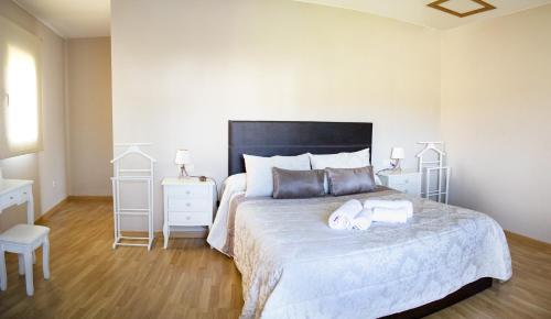 a bedroom with a large bed with two towels on it at Casa Maia in A Coruña