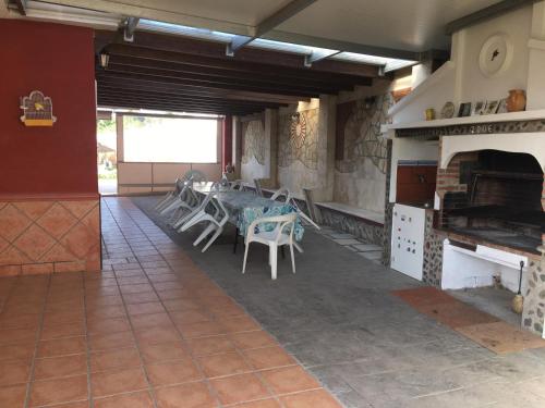 a room with a table and chairs and a fireplace at Casa campo Ramos in Cártama