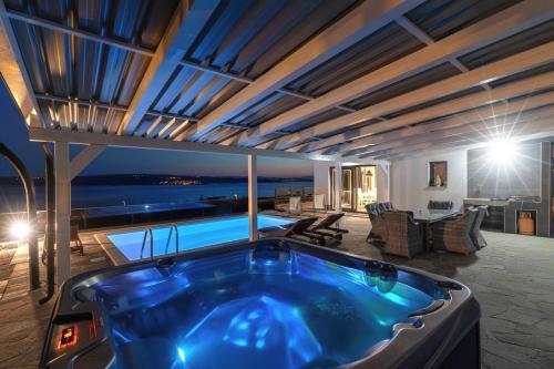 a jacuzzi tub in the middle of a house at Villa Belissima Vista Mare in Selce