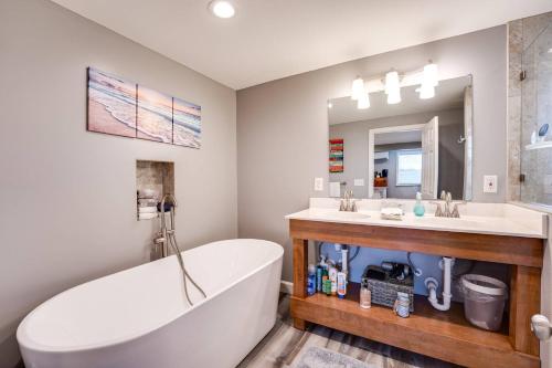 a bathroom with a tub and a sink and a bath tub at Gem 3 in Jacksonville Beach