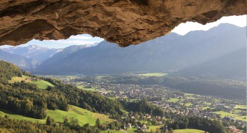 a view of a village from a cave in a mountain at Ferienwohnung Stoablick - barrierefrei mit Bergblick in Bad Goisern