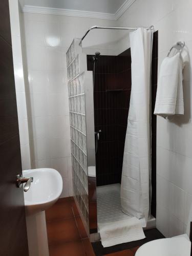 a bathroom with a shower and a sink at Hostal Andalucía in Chipiona
