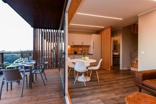 a living room and kitchen with a table and chairs at wecamp Reserva Alecrim in Santiago do Cacém