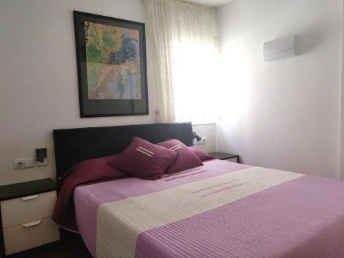 - une chambre dotée d'un lit avec une couverture violette et blanche dans l'établissement Beautiful Apartment, Swimming Pool and Beach 1, à Platja d'Aro