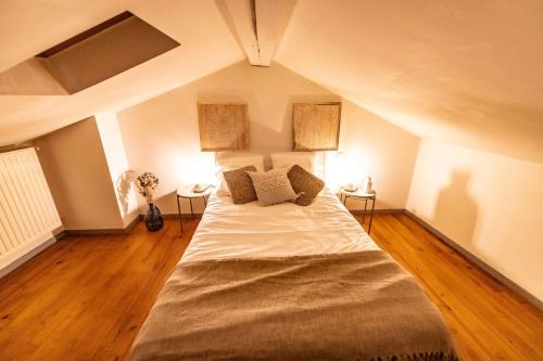 a bedroom with a large bed in an attic at Duplex Typique Centre Bayonne in Bayonne