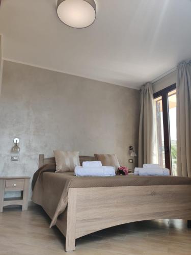 a bedroom with a large bed with two pillows at Raggi di Sole in Custonaci