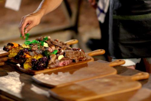 a person is preparing food on a cutting board at wecamp Reserva Alecrim in Santiago do Cacém