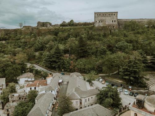 an aerial view of a town with a castle on a hill at Grey Stone in Gjirokastër