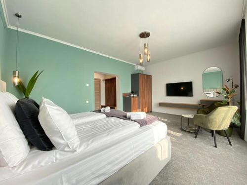 a bedroom with a large white bed and a desk at CoolKush Boutique in Constanţa
