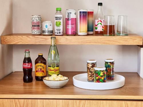 a shelf with bottles of alcohol and a bowl of popcorn at Hotel June Malibu in Malibu