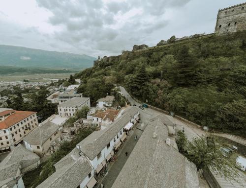 a view of a city with a hill and buildings at Grey Stone in Gjirokastër