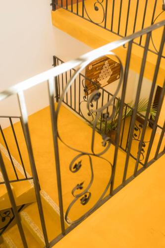 a staircase with a wrought iron railing and a wooden floor at Pousada Ouro de Minas in Tiradentes