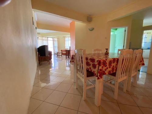 a dining room with a table and chairs at Aadi Villa in Mont Choisy
