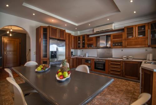 a kitchen with a table with a bowl of fruit on it at Akrata's Elegant Luxury Suite in Akrata