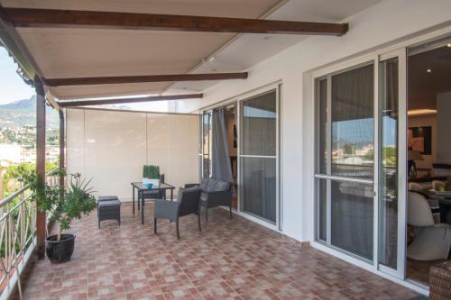 a patio with chairs and a table on a balcony at Akrata's Elegant Luxury Suite in Akrata