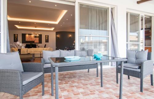 a living room with a glass table and chairs at Akrata's Elegant Luxury Suite in Akrata