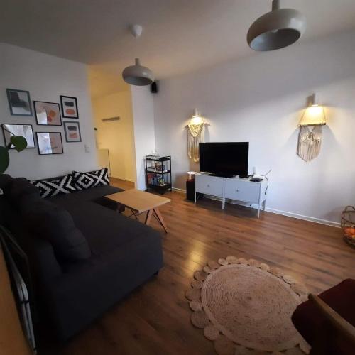 a living room with a couch and a flat screen tv at M37 x Fabryczna in Limanowa