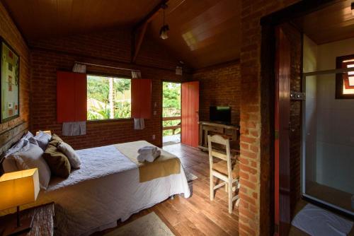 Una cama o camas en una habitación de Minha Glória Hotel Boutique