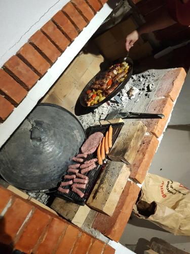 a grill with hot dogs and other food on it at Sarajevo Sky View in Sarajevo