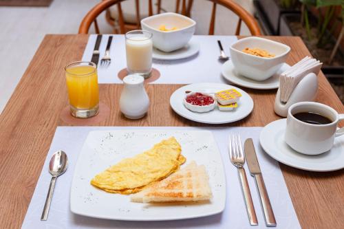 a table with a plate of breakfast food and coffee at Equo Hotel Boutique in Lima