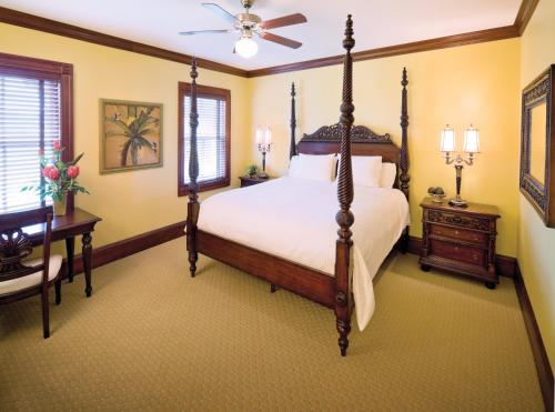 a bedroom with a bed and a desk and a fan at Club Wyndham Dye Villas in North Myrtle Beach