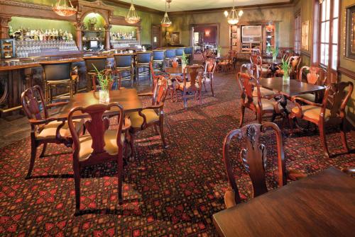 a restaurant with tables and chairs and a bar at Club Wyndham Dye Villas in North Myrtle Beach