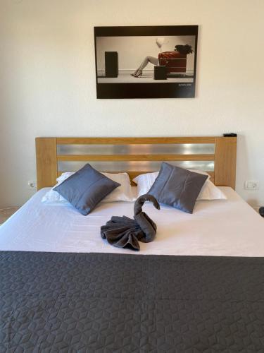 a bedroom with a bed with a robe on it at Villa Sun&Sea in Komarna