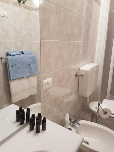 a bathroom with a sink and a toilet and a mirror at Casa Mafalda in Corniglia