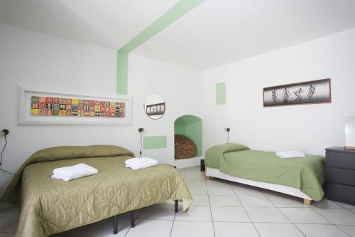 a room with two beds and a tv in it at PALAZZO PELLEGRINO vietri in Vietri sul Mare