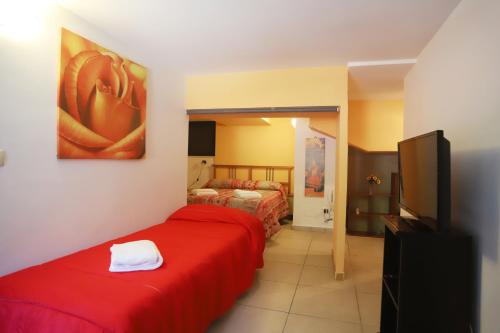 a hotel room with two beds and a television at PALAZZO PELLEGRINO vietri in Vietri sul Mare