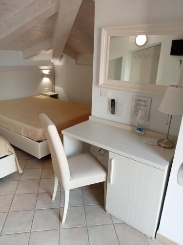 a bedroom with a desk and a bed at Borgo 800 in San Nicola Arcella