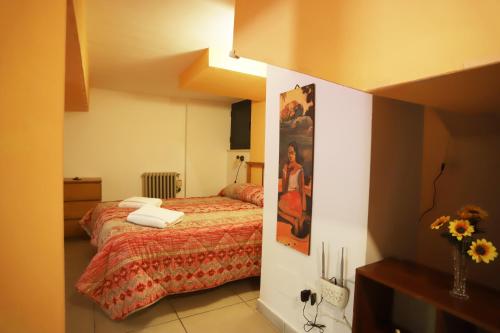 a bedroom with a bed and a painting on the wall at PALAZZO PELLEGRINO vietri in Vietri sul Mare
