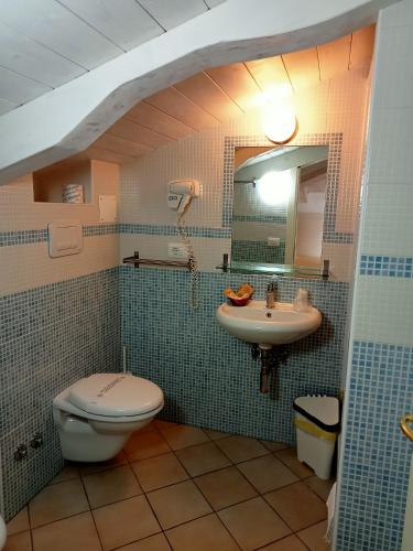 a bathroom with a toilet and a sink at Borgo 800 in San Nicola Arcella