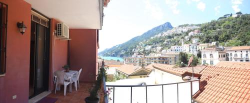 a balcony with a table and a view of a city at PALAZZO PELLEGRINO vietri in Vietri sul Mare