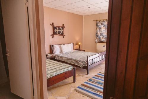 a small bedroom with a bed and a window at Sayadeen Village - Red Sea Riviera in Nuweiba