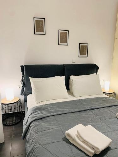 a bedroom with a large bed with two towels on it at Elegant Apartment Keramoti in Keramoti