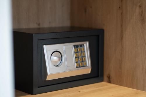 a small black and white safe sitting on a table at Panorama Hill Hotel in Iraklitsa
