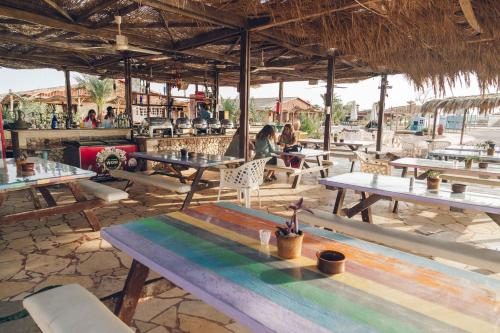 a group of tables and chairs in a restaurant at Sayadeen Village - Red Sea Riviera in Nuweiba