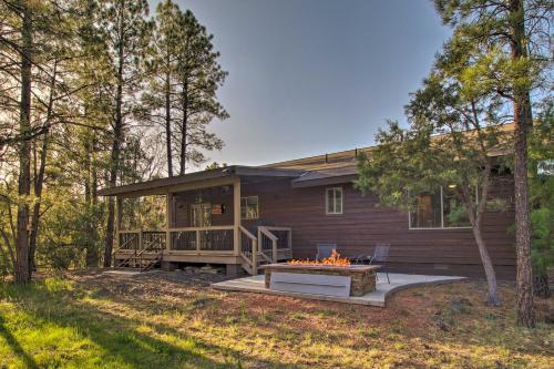 a house with a fire pit in front of it at 1 Mi to Rainbow Lake Newly Built and Woodsy Retreat in Lake of the Woods
