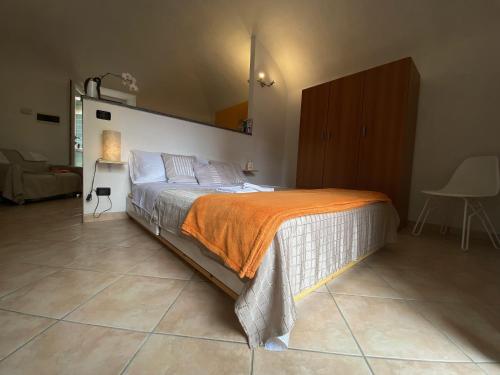 a bedroom with a bed with an orange blanket at Quick Home - Interno 45 in Biella